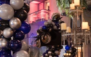 Colorful balloon decorations in black, silver, and blue, with eerie eye motifs, set the mood for the Halloween event.
